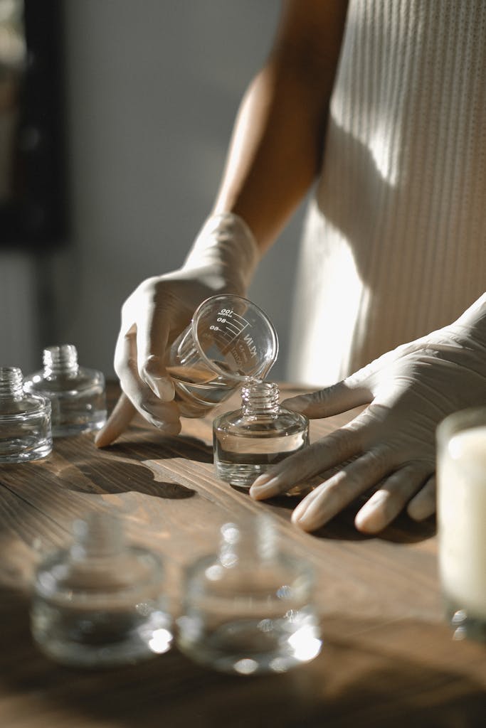 Crop black woman making aromatic liquid incense